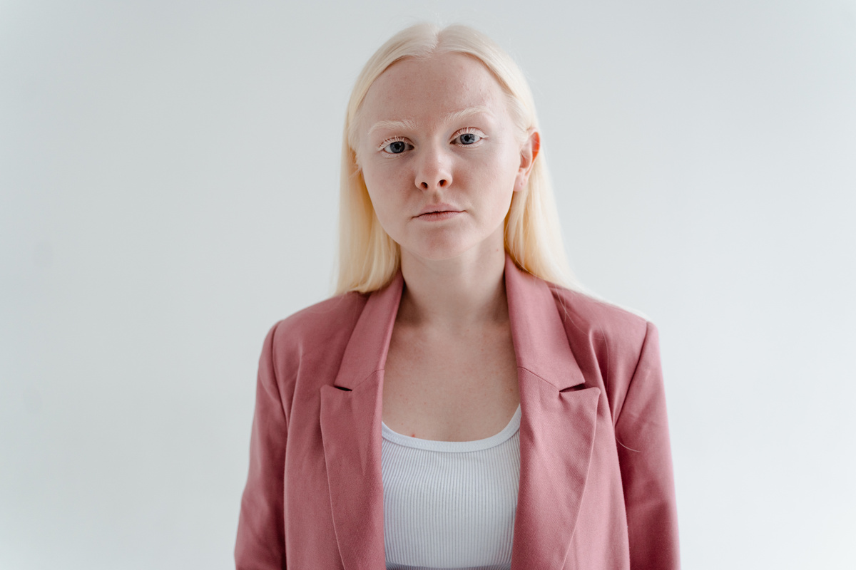 Portrait of a Woman with Blonde Hair Wearing a Pink Blazer